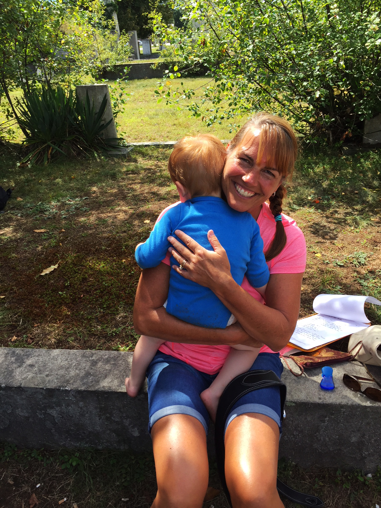 Dawn Longval hugging toddler in the park during summer.